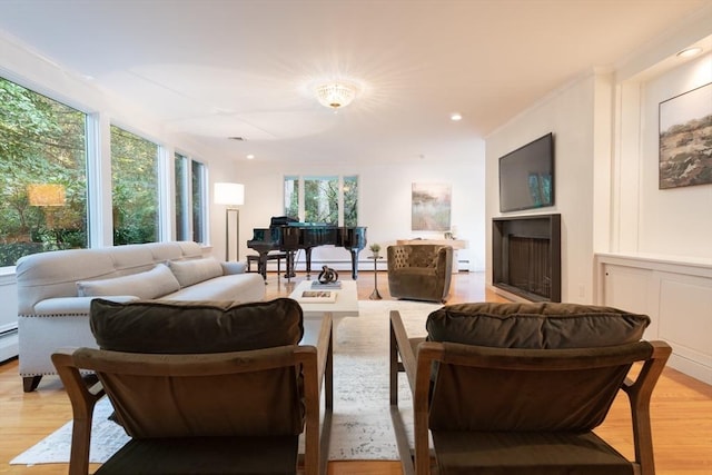 living room featuring baseboard heating and light hardwood / wood-style floors