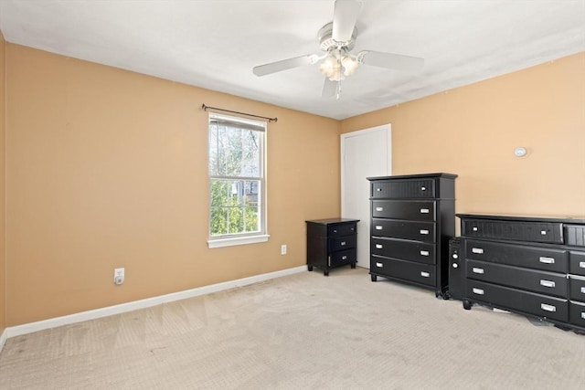 unfurnished bedroom with baseboards, carpet flooring, and a ceiling fan