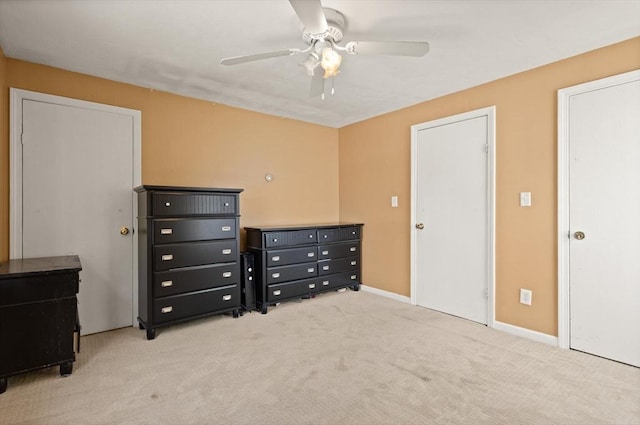 carpeted bedroom featuring baseboards and a ceiling fan