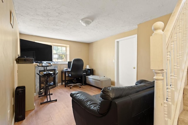 home office featuring a textured ceiling and wood finished floors