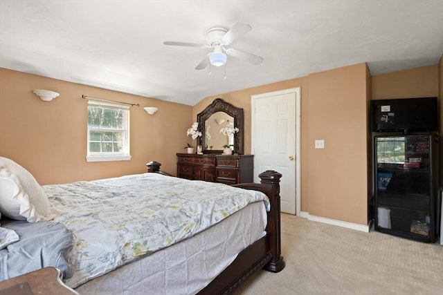 bedroom with a ceiling fan, baseboards, light colored carpet, and wine cooler