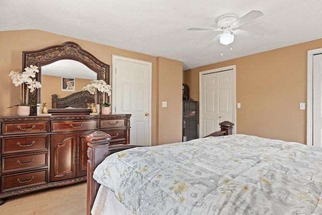 bedroom with ceiling fan and light colored carpet
