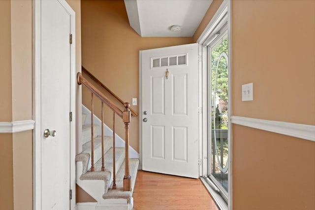 foyer entrance with stairway and wood finished floors