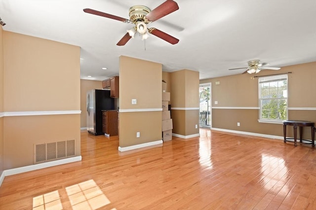 unfurnished living room with visible vents, light wood-style floors, baseboards, ceiling fan, and recessed lighting