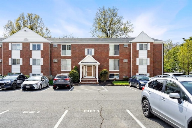 view of building exterior featuring uncovered parking
