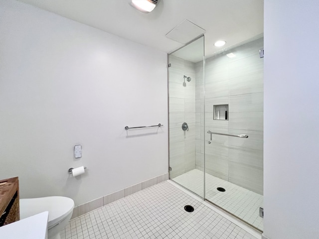 bathroom featuring a shower with door, tile patterned floors, vanity, and toilet