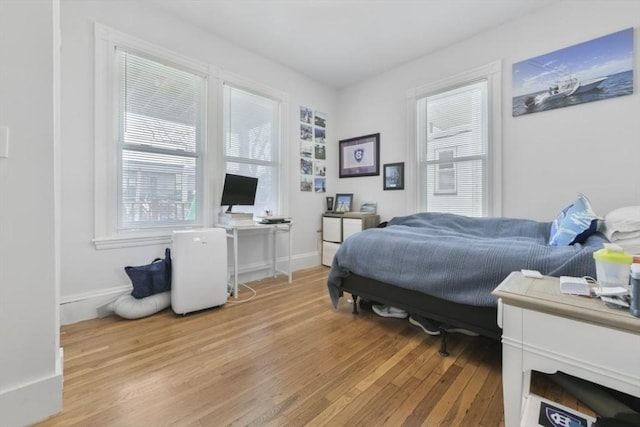 893 E 4th St, Boston, MA 02127 - bedroom featuring light wood-style flooring, multiple windows, and an office area