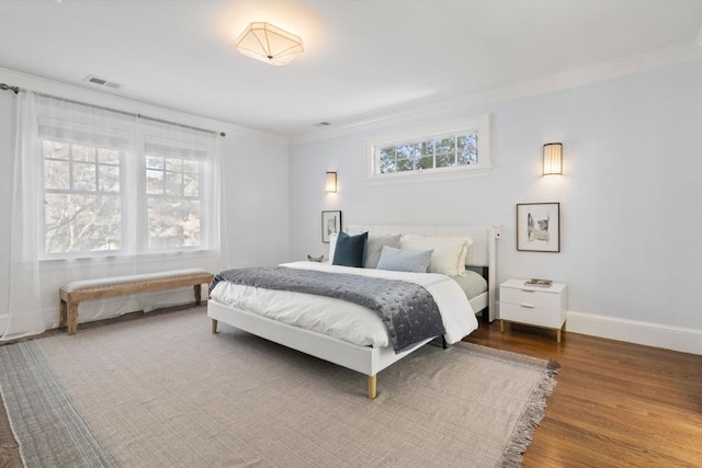 bedroom featuring crown molding and wood-type flooring