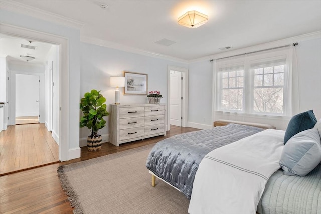 bedroom with crown molding and wood-type flooring