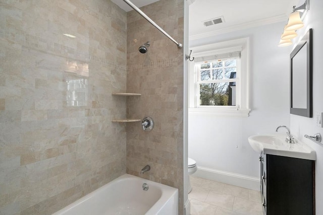 full bathroom featuring tile patterned floors, toilet, ornamental molding, vanity, and tiled shower / bath combo