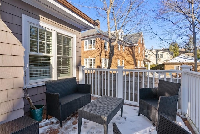 snow covered patio with a deck