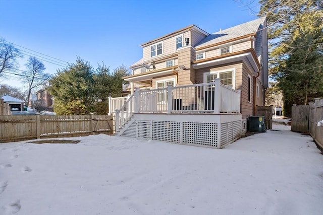 rear view of house featuring central AC and a deck