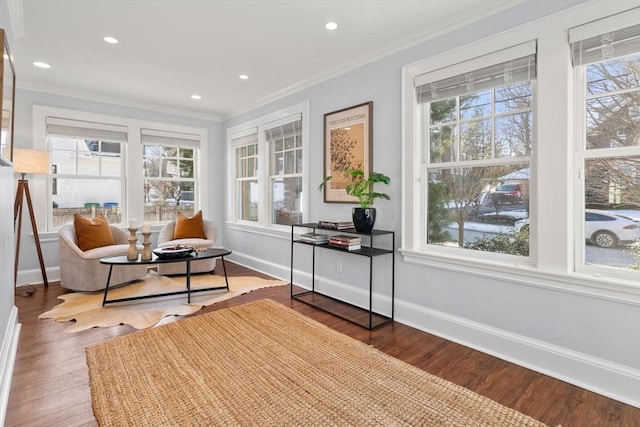 sitting room featuring hardwood / wood-style flooring and ornamental molding