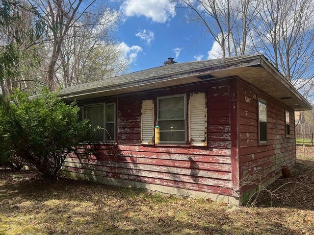 view of property exterior featuring a chimney