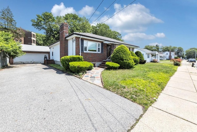 35 Freeman Ave, Boston, MA 02132 - bungalow-style house with brick siding, a chimney, a front lawn, and asphalt driveway