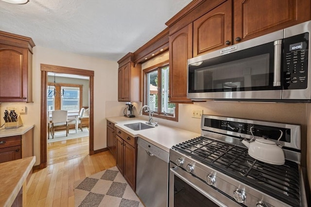 41 Dale Ave, Quincy, MA 02169 - kitchen with appliances with stainless steel finishes, light countertops, light wood finished floors, and brown cabinetry