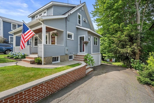41 Dale Ave, Quincy, MA 02169 - view of front of house with asphalt driveway, a garage, covered porch, and a front lawn