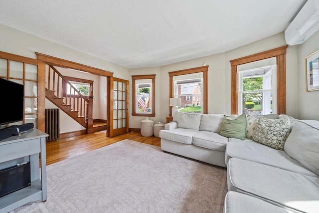 41 Dale Ave, Quincy, MA 02169 - living room with a wall unit AC, wood finished floors, and stairs