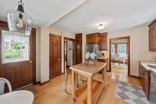 41 Dale Ave, Quincy, MA 02169 - kitchen featuring appliances with stainless steel finishes, light wood-style floors, light countertops, and a textured ceiling