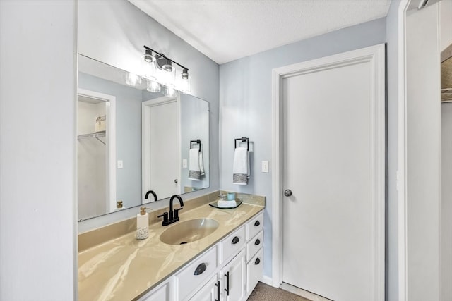 bathroom with vanity and a textured ceiling