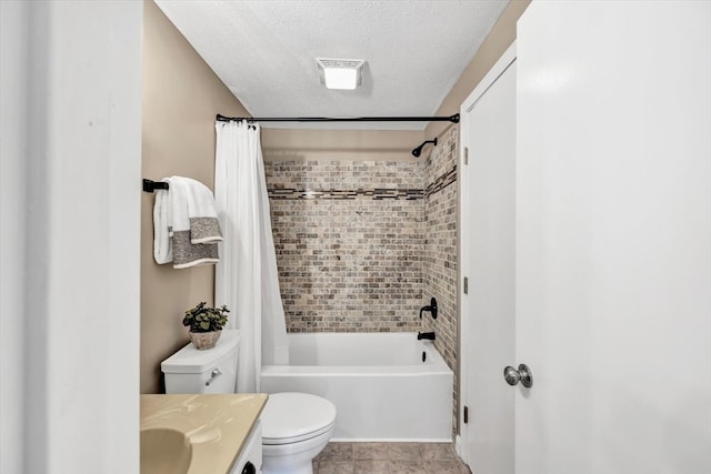 full bathroom featuring vanity, a textured ceiling, shower / bath combo with shower curtain, tile patterned floors, and toilet