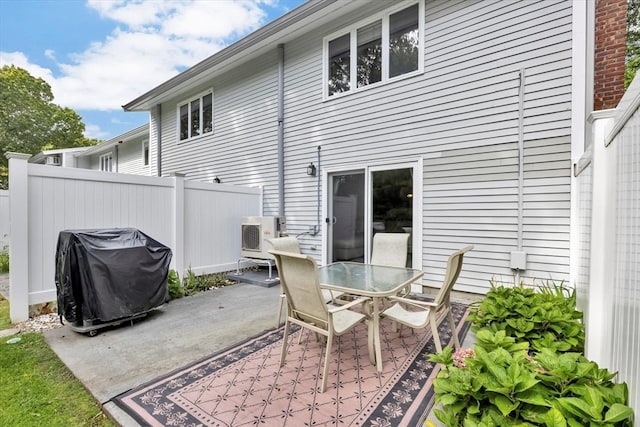 rear view of property featuring ac unit and a patio