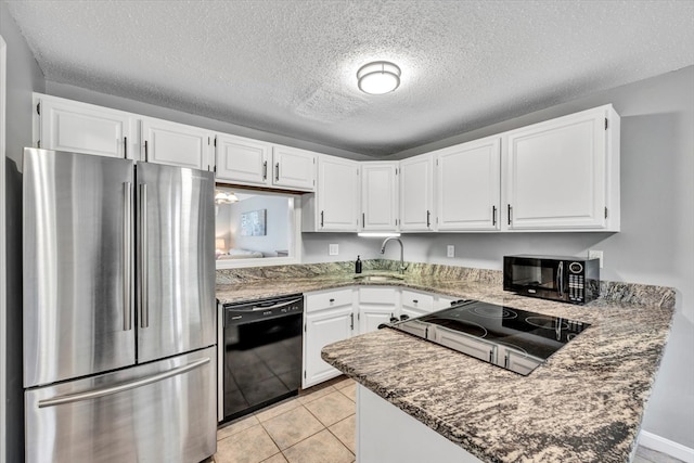 kitchen with white cabinets, a textured ceiling, sink, and black appliances