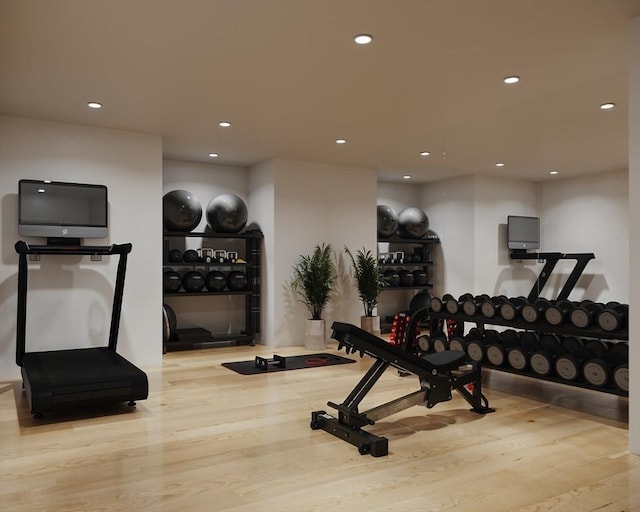 workout area with light hardwood / wood-style floors