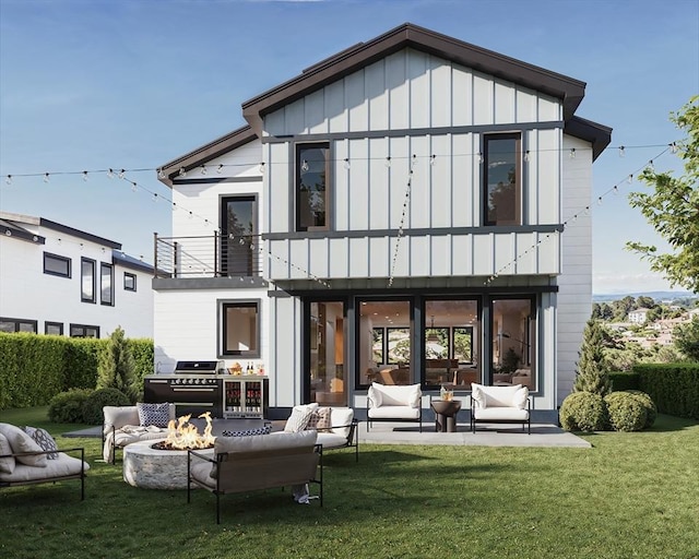 back of property with a patio area, a balcony, a yard, and an outdoor living space with a fire pit