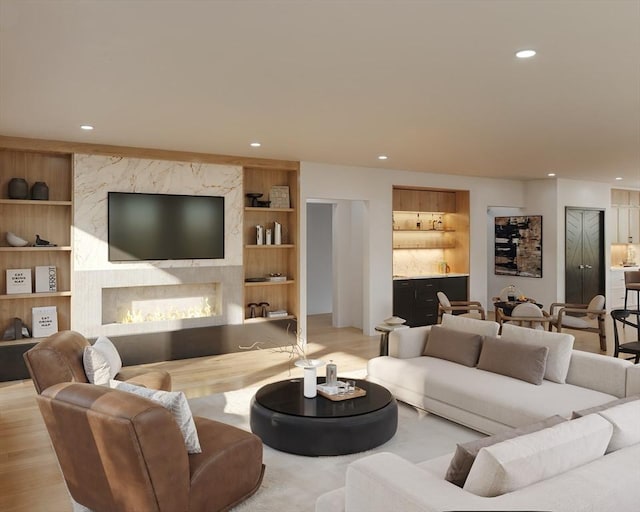 living room with built in features and light wood-type flooring