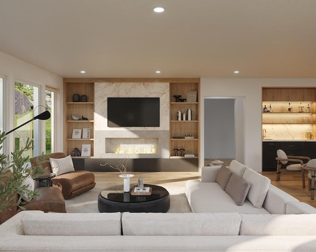 living room with built in features and wood-type flooring