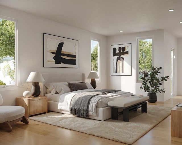 bedroom featuring light hardwood / wood-style floors and multiple windows