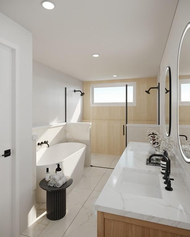 bathroom featuring a tub to relax in and vanity