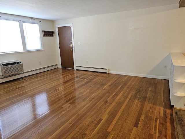 empty room with baseboards, a baseboard heating unit, a wall unit AC, and wood finished floors