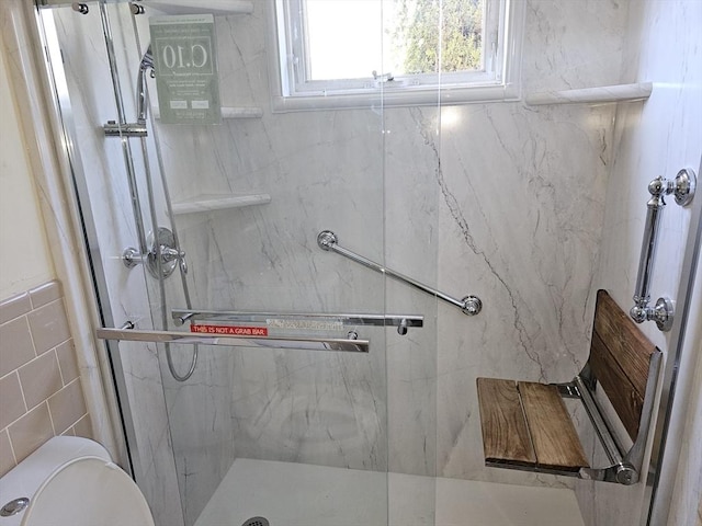 full bathroom with toilet, tile walls, and a marble finish shower