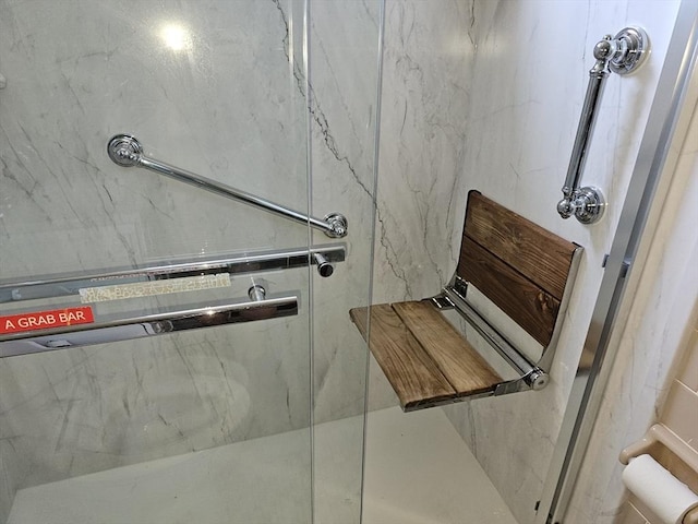 full bath with a marble finish shower