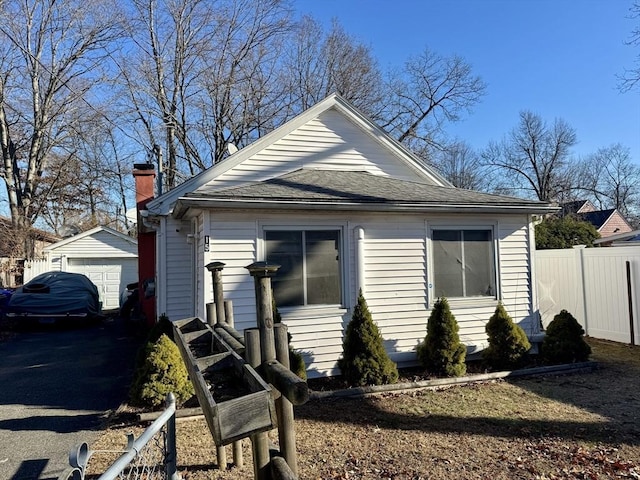 bungalow-style house featuring an outbuilding and a garage