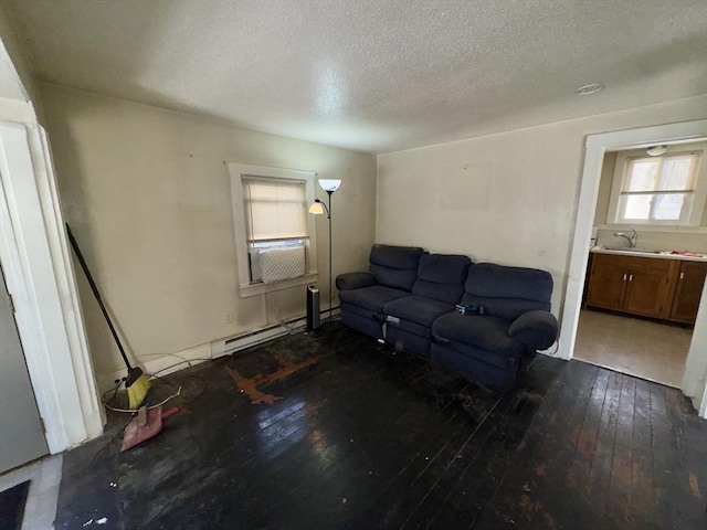 living room featuring a baseboard radiator, sink, a textured ceiling, and dark hardwood / wood-style flooring