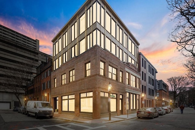 view of outdoor building at dusk