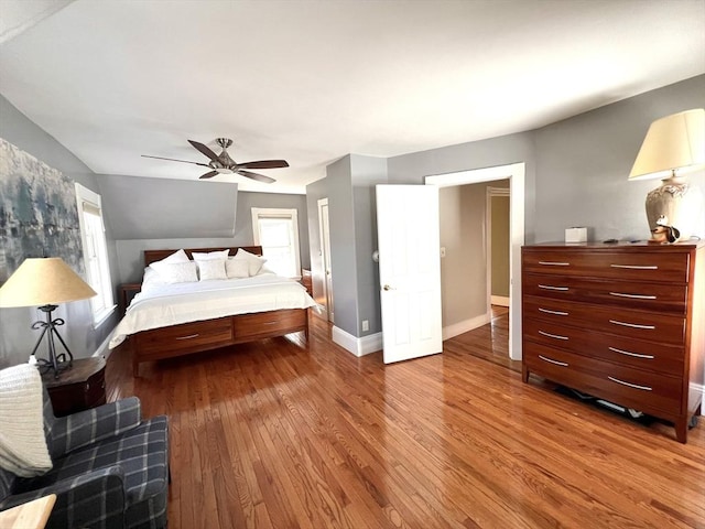 bedroom featuring wood finished floors, baseboards, and ceiling fan