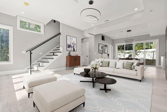 living room featuring light wood-style flooring, stairs, crown molding, and recessed lighting