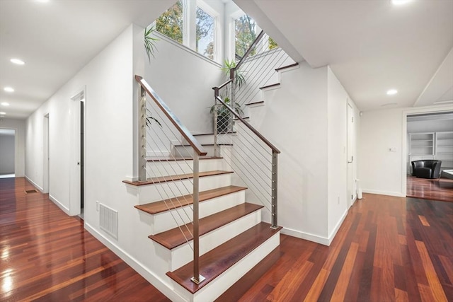 staircase with wood-type flooring