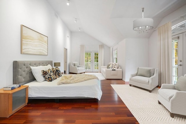 bedroom with vaulted ceiling, access to exterior, a chandelier, and dark hardwood / wood-style floors