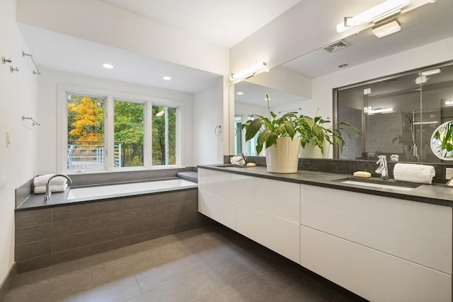 bathroom with vanity, tile patterned flooring, and shower with separate bathtub