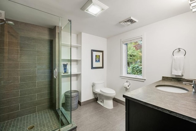 bathroom with toilet, an enclosed shower, and vanity