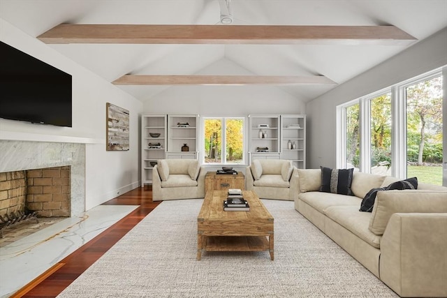 living room with dark hardwood / wood-style floors, a fireplace, and vaulted ceiling with beams