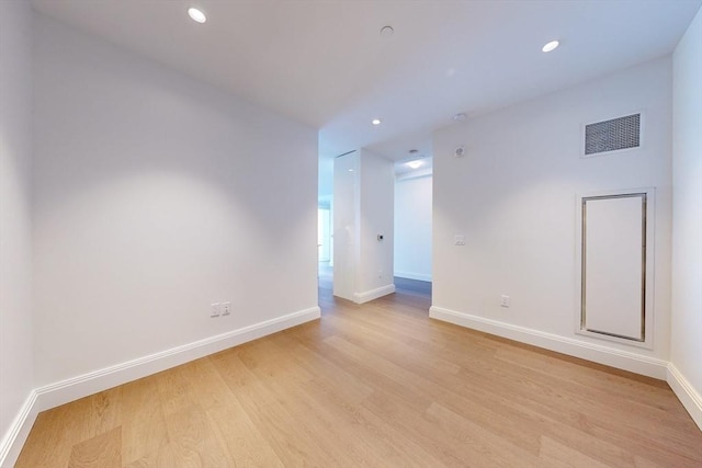 unfurnished room with light wood-type flooring