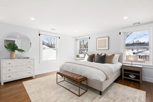 bedroom with dark hardwood / wood-style floors