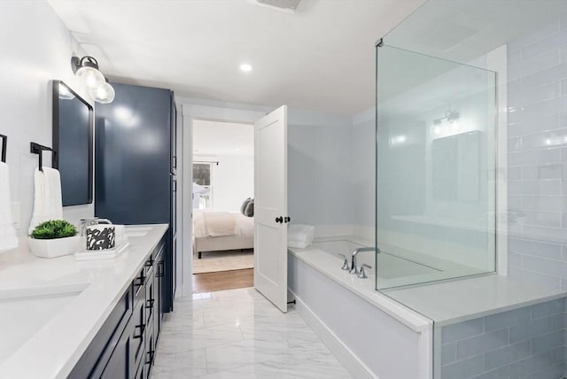 bathroom featuring vanity and a tub