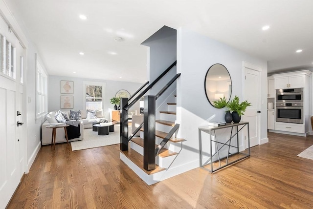 stairway with hardwood / wood-style flooring